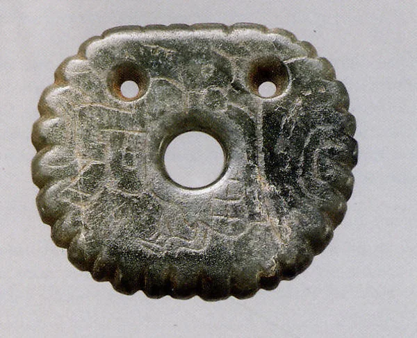 Finished jadeite ornament carved with a Maya glyph