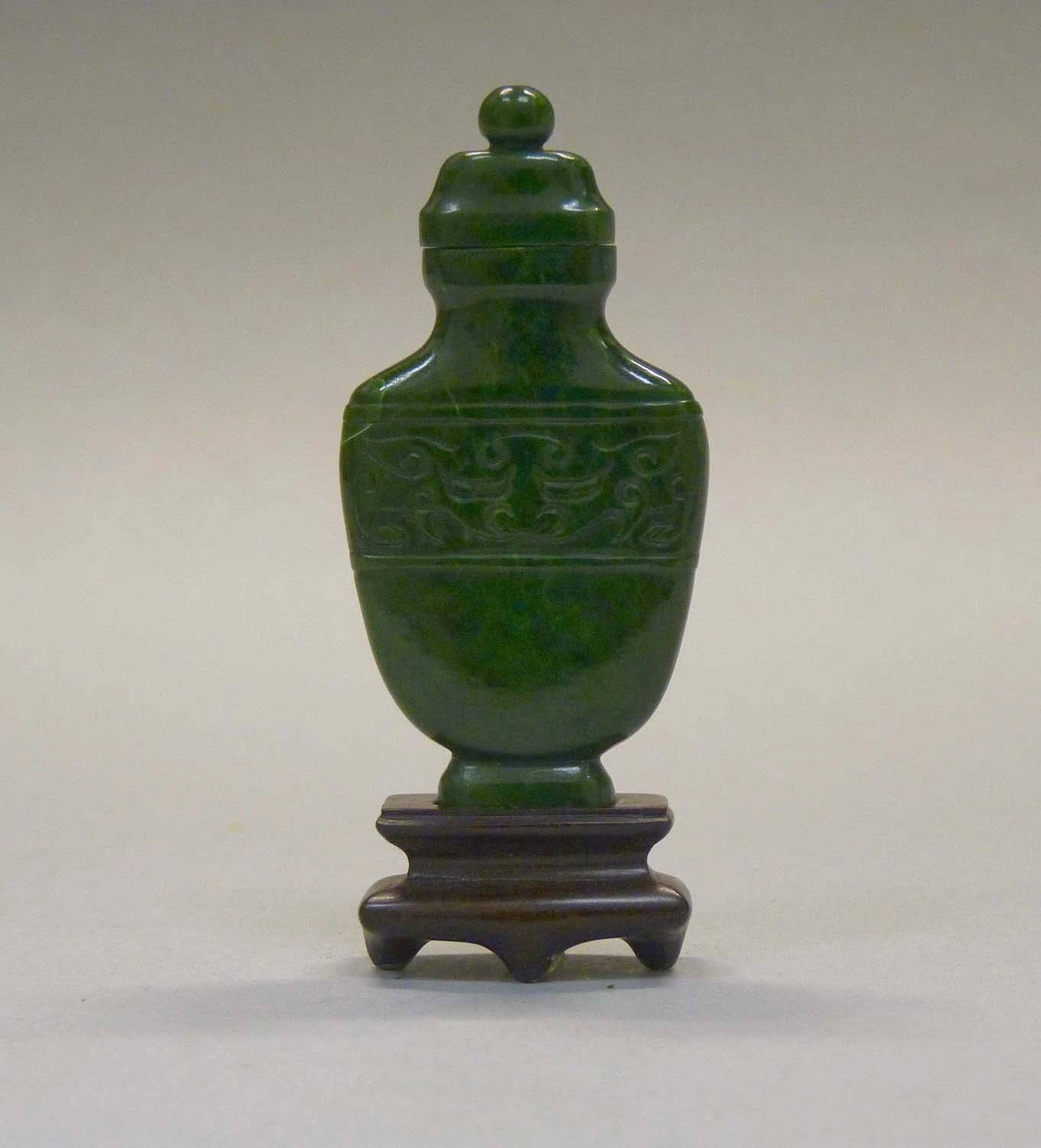 Dark chloromelanite jadeite snuff bottle with limited transmitted appearance